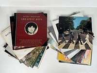 Stacks of LPs, top covers Linda Ronstadt Greatest Hits and The Beatles Abbey Road