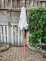 Umbrella collapsed showing full wood pole and canopy