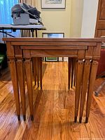 Three nested wooden tables front view