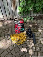 Blower, extension cord, box displayed on patio