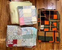 All four folded textiles on floor