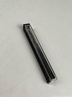 Pen inside original clear-top plastic case showing full length and gold-tone clip