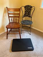 Two chairs and knee pad displayed together