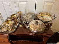 Group shot of all seven silver items on shelf