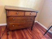 Front view of oak dresser showing drawer arrangement and hardware
