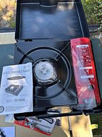 Single-burner butane stove CI-153S with manual and fuel canister in open case