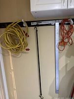 Overall lot showing cords, T-square and wall rod hanging