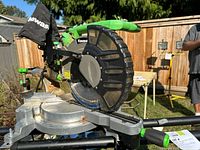 Left side view of Kawasaki sliding compound miter saw mounted on Ryobi stand
