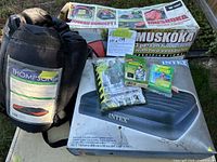 All items together: tent box, sleeping bag, air mattress box, poncho, two emergency blankets