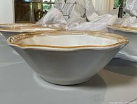 Side view of scalloped bowl showing rim color and glossy finish