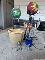 Group shot of two mosaic balls on stands, terracotta planter, cobalt pot