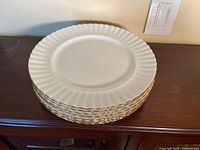 Stack of eight Royal Albert Val D'Or dinner plates
