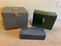 All three metal boxes grouped to show relative size and colour
