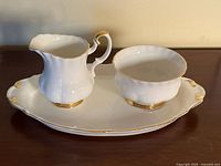 Full view of creamer, sugar bowl and tray