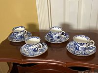 Full set of four teacups and saucers displayed