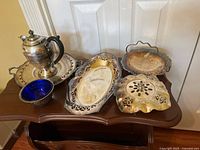 Group shot of all six silver-plate pieces on table