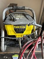 Front view of Wagner Paint Crew sprayer showing tank, frame and hose