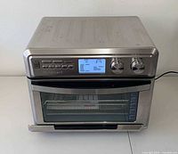 Front view of stainless steel Cuisinart digital air fryer toaster oven showing display and door