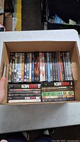 Open box showing rows of DVD spines