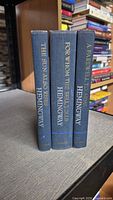 Spines of three Hemingway blue cloth hardcovers