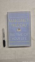 Front cover of signed Margaret Trudeau hardcover book beside marker for scale