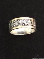 Ring front view showing spiral design and gold border
