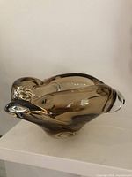 Oblique view of smoked brown sommerso bowl showing free-form shape and clear rim