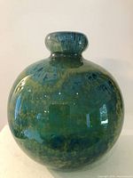 Full view of spherical Mdina glass vase showing color pattern