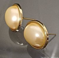 Front view showing both faux pearls and gold bezels