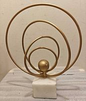 Front view of concentric rings sculpture on marble base