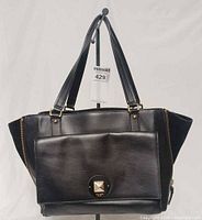 Front view showing overall design, front flap pocket and hardware