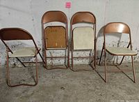 Four folding chairs angled to show fronts and sides