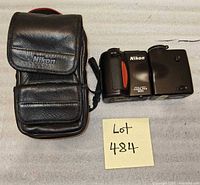 Camera with lens cap and leather case