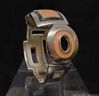 Side view showing openwork rectangular links with enamel insets and circular disc accent