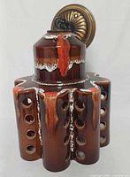 Front view of pottery pendant lamp showing glaze and perforations