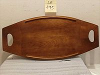 Top view of wooden serving tray showing shape, handles, surface