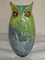 Front view of owl-shaped art glass vase showing eyes and color gradient