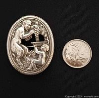 Brooch beside Canadian dime for scale