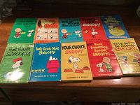 Front covers of the ten Snoopy books
