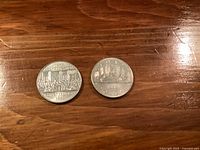 Reverse of two 1982 Canadian dollar coins showing commemorative Constitution design and Voyageur canoe design