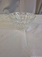 Side view of clear lead crystal bowl, shows scalloped rim and cut pattern