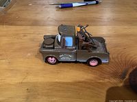 Left side view of Tow Mater truck showing body, wheels, door logo