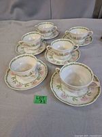 Six soup cups with saucers displayed