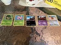 All five Pokémon cards laid out on table