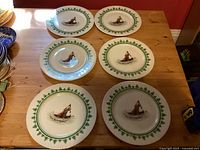 Six matching dinner plates displayed top view