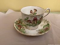 Cup on saucer showing full floral pattern and gold trim