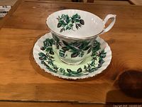Cup and saucer front view showing pattern and gold trim