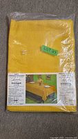 Front view of sealed yellow Leacock tablecloth package showing overall item