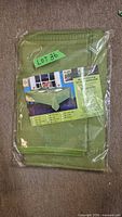 Front of sealed package showing green tablecloth set