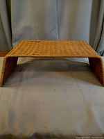 Front view of rectangular woven rattan bed tray showing overall shape and weave